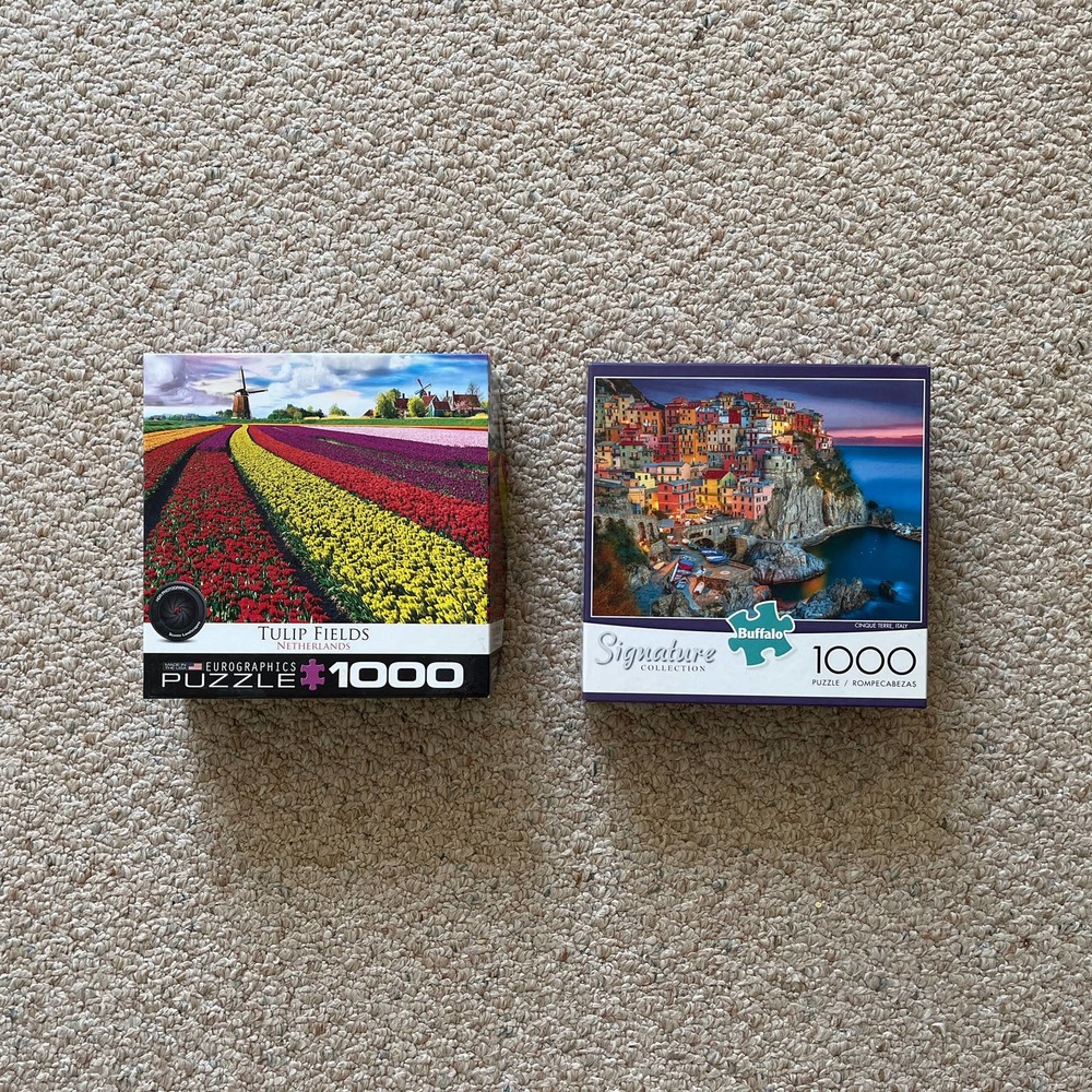Lot of two colorful 1,000 piece puzzles of European landscapes. GUC
